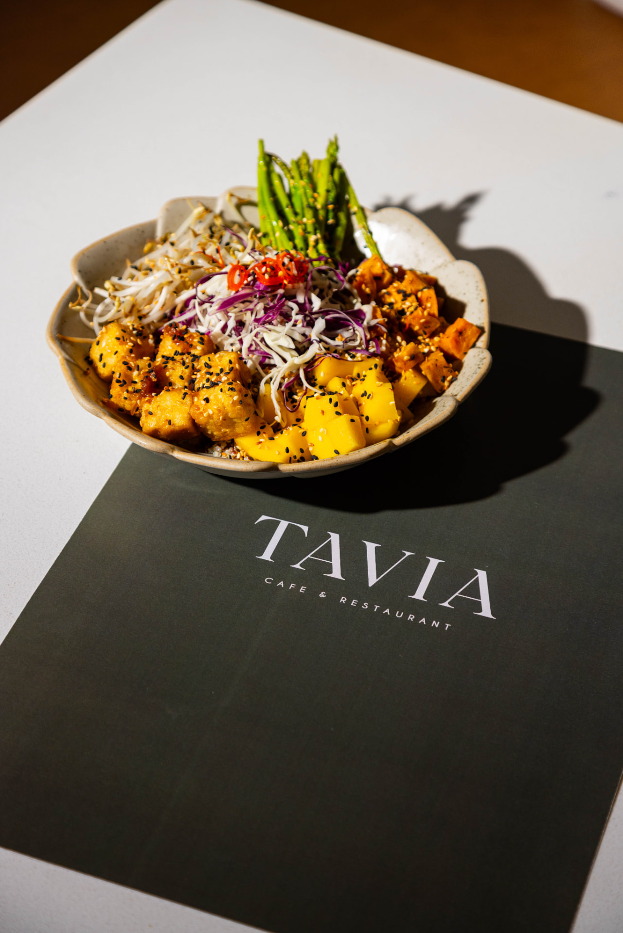A vibrant seasonal poke bowl with tofu, mango, roasted vegetables and asparagus at Tavia Cafe & Restaurant in Dubai Silicon Oasis