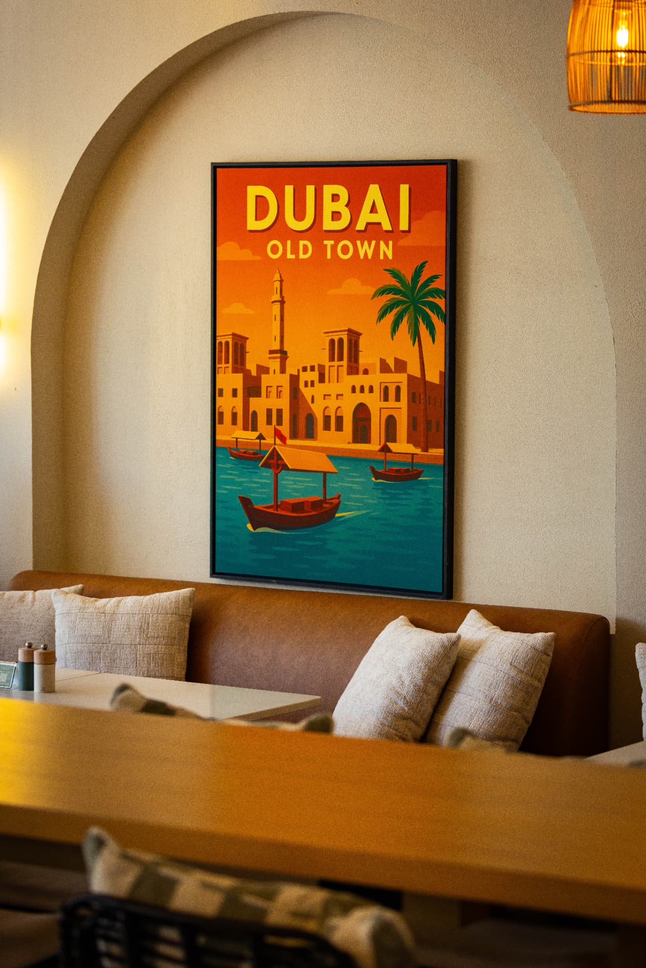 Tavia dining room with leather banquette, linen cushions and a Dubai Old Town poster